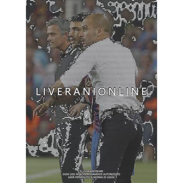 FC Barcelona\'s coach coach Pep Guardiola and Cesc Fabregas (c) in presence of Real Madrid\'s coach Jose Mourinho during Spanish Supercup 2nd match.August 17,2011. Photo: Acero / Alter / ALFAQUI Photo: Acero / Alter / ALFAQUI