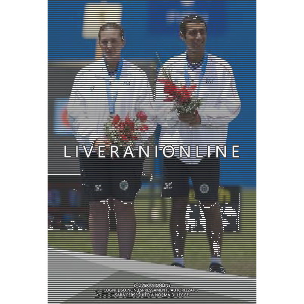 (110818) -- SHENZHEN, Aug. 18, 2011 () -- Anastasia Anastasio and Jacopo Polidori of Italy pose for photos during the awarding ceremony of mixed team compound of archery at the 26th Summer Universiade in Shenzhen, a city of south China\'s Guangdong Province, on Aug. 18, 2011. Anastasia Anastasio and Jacopo Polidori won the bronze medal in the event. (/Lui Siu Wai)(wx)