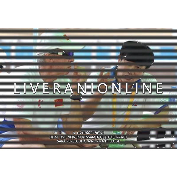 (110818) -- SHENZHEN, Aug. 18, 2011 () -- Chief coach of Chinese cycling team Daniel Morelon (L) talks with Shen Jinkang, head coach of China\'s Hong Kong cycling team during cycling track matches at the 26th Summer Universiade in Shenzhen, a city of south China\'s Guangdong Province, on Aug. 18, 2011. (/Li Ga)(wx)