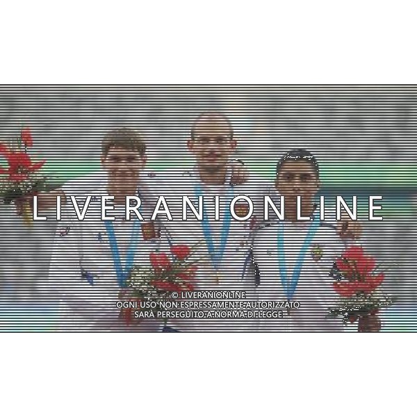 (110818) SHENZHEN, Aug. 18, 2011 Gold medalist Andrey Krivov of Russia (C), his teammate silver medalist Mikhail Ryzhov (L) and bronze medalist Cristian Andres Chocho Leon of Ecuador celebrate during awarding ceremony for the men\'s 20km walk individual final of athletics event at the 26th Summer Universiade, in Shenzhen, a city of south China\'s Guangdong Province, Aug. 18, 2011. Krivov won the title of the event with 1 hours 24 minutes 15 seconds. (/Liao Yujie) (bxf)