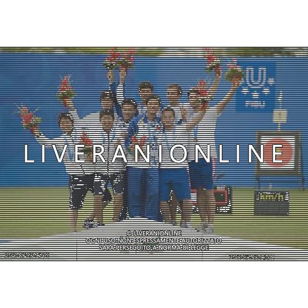 (110818) SHENZHEN, Aug. 18, 2011 Gold medalists team of China (C), silver medalists team of Japan (L) and bronze medalists team of France celebrate during the awarding ceremony for the men\'s team recurve bow match of archery event at the 26th Summer Universiade, in Shenzhen, a city of south China\'s Guangdong Province, Aug. 18, 2011. (/Lui Siu Wai)(bxf)