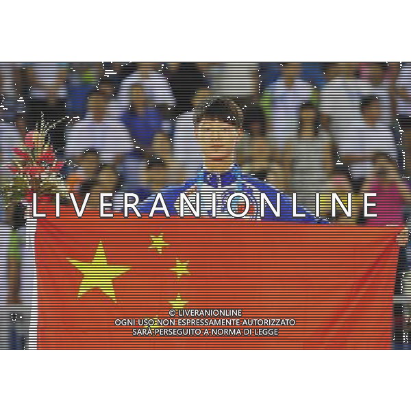 (110818) SHENZHEN, Aug. 18, 2011 Zhu Yuxiang of China celebrates with his national flag during the awarding ceremony for the men\'s individual poomsae of taekwondo at the 26th Summer Universiade in Shenzhen, a city of south China\'s Guangdong Province Aug. 18, 2011. Zhu Yuxiang claimed the title of the event with 8.65 points. (/Liang Xu)(wll)