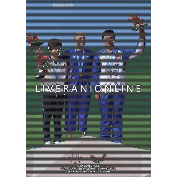 (110818) SHENZHEN, Aug. 18, 2011 Gold medalist Niccolo Campriani of Italy (C), silver medalist Yu Jae Chul of South Korea, and bronze medalist Gong Jiawei of China celebrates during the awarding ceremony of men\'s 10m air rifle individual of shooting at the 26th Summer Universiade in Shenzhen, a city of south China\'s Guangdong Province, Aug. 18, 2011. (/Chen Yehua)