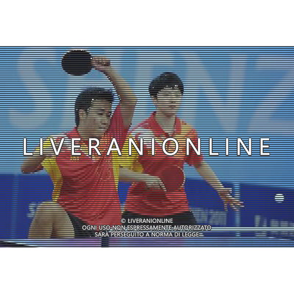 (110818) SHENZHEN, Aug. 18, 2011 China\'s Shang Kun (L) and Rao Jingwen compete during the mixed doubles finals of table tennis event against Japan\'s Isshigaki Ya and Miuchi Kentaro at the 26th Summer Universiade, in Shenzhen, a city of south China\'s Guangdong Province, Aug. 18, 2011. Shang/Rao won 4 0 to got the gold medal. (/Yang Shiyao)(bxf)