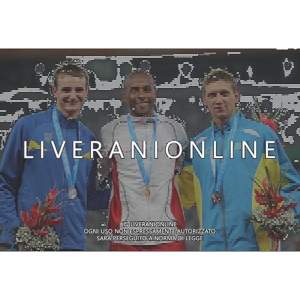 (110818) -- SHENZHEN, Aug. 18, 2011 () -- Gold medalist Nelson Evora of Portugal (C), silver medalist Viktor Kuznietsov of Ukraine (L) and bronze medalist Yevgeniy Ektov of Kazakstan celebrate during the awarding ceremony for the men\'s triple jump finals of athletics event at the 26th Summer Universiade, in Shenzhen, a city of south China\'s Guangdong Province, Aug. 18, 2011. Nelson Evora won the gold medal with 17.31 meters. (/Li Ming) (bxf)