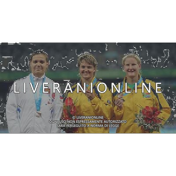 (110818) -- SHENZHEN, Aug. 18, 2011 () -- Gold medalist Sunette Stella Viljoen (C) of South Africa, silver medalist Marina Maximova (L) of Russia and bronze medalist Justine Gail Robbeson of South Africa react during the women\'s javelin awarding ceremony of athletics competition at the 26th Summer Universiade in Shenzhen, a city of south China\'s Guangdong Province, Aug. 18, 2011. (/Li Ming)