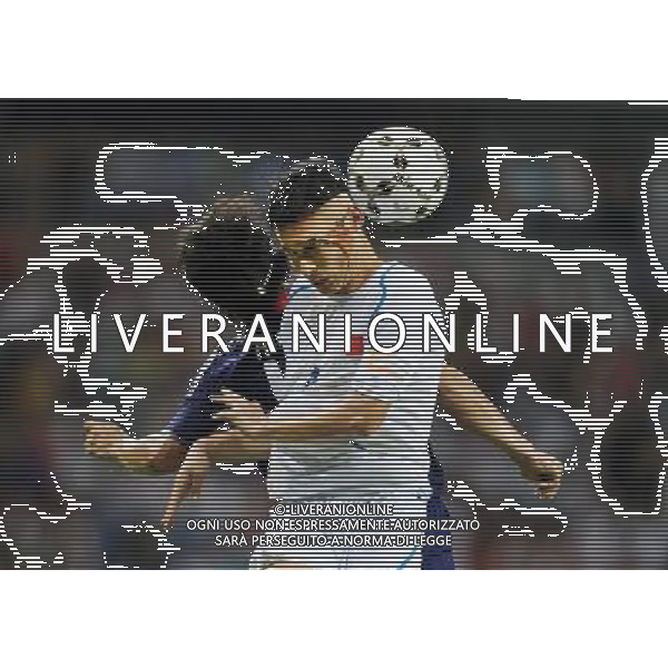(110818) -- SHENZHEN, Aug. 18, 2011 () -- Lu Bin of China (R) heads the ball during the men\'s football quarterfinal against Japan at the 26th Summer Universiade, in Shenzhen, a city of south China\'s Guangdong Province, Aug. 18, 2011. Japan won 3-2 to enter the semifinals. (/Li Ga)(bxf)