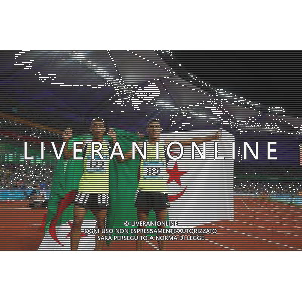 (110818) -- SHENZHEN, Aug. 18, 2011 () -- Imad Touil of Algeria (L) celebrates with his teammate Abdelmadjed Touil after winning the men\'s 1500m final race of athletics event at the 26th Summer Universiade, in Shenzhen, a city of south China\'s Guangdong Province, Aug. 18, 2011. Imad Touil won the gold medal with 3 minutes 48.13 seconds. (/Liao Yujie) (bxf)