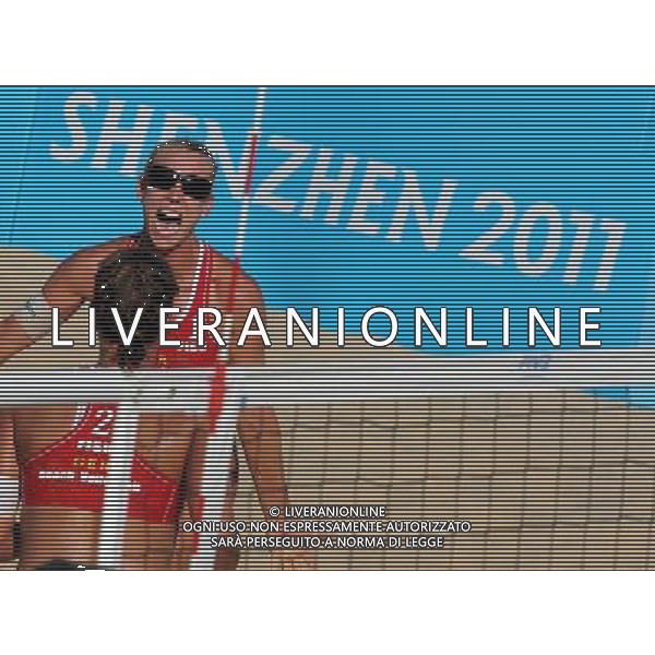 (110819) -- SHENZHEN, Aug. 19, 2011 () -- Karla Borger (rear) and Britta Kristin Buethe of Germany celebrate for victory after the women\'s beach volleyball gold medal match against Heather Hughes and Emily Day of the United States at the 26th Summer Universiade in Shenzhen, a city of south China\'s Guangdong Province, Aug. 19, 2011. Karla Borger and Britta Kristin Buethe won 2-0 to claim the gold. (/Gong Lei)(lm)