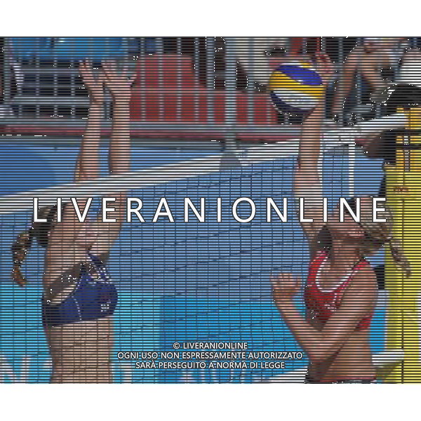 (110819) -- SHENZHEN, Aug. 19, 2011 () -- Karla Borger (R) of Germany spikes the ball during the women\'s beach volleyball gold medal match against Heather Hughes and Emily Day of the United States at the 26th Summer Universiade in Shenzhen, a city of south China\'s Guangdong Province, Aug. 19, 2011. Karla Borger and Britta Kristin Buethe won 2-0 to claim the gold. (/Guo Yong)(lm)
