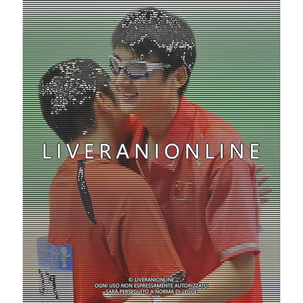 (110819) -- SHENZHEN, Aug. 19, 2011 () -- Chinese shooters Ding Feng (L) and Zhou Zhiguo congradulate each other during the 25m rapid fire pistol men individual of shooting event at the 26th Summer Universiade in Shenzhen, a city of south China\'s Guangdong Province, on Aug. 19, 2011. Ding Feng claimed the title of the event, while Zhou Zhiguo won the silver medal. (/Chen Yehua)