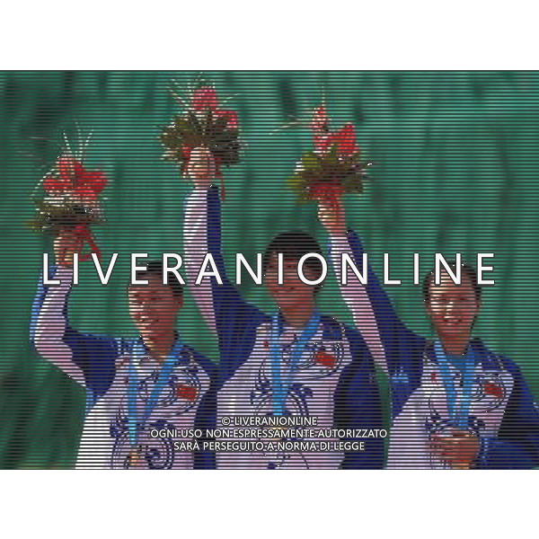 (110820) -- SHENZHEN, Aug. 20, 2011 () -- Lu Min, Yu Xiumin and Yang Jing of China celebrate during the awarding ceremony of the women\'s skeet team of shotgun at the 26th Summer Universiade in Shenzhen, a city of south China\'s Guangdong Province, Aug. 20, 2011. The team of China claimed the gold medal of the event with a total of 204 hits. (/Lin Yiguang)