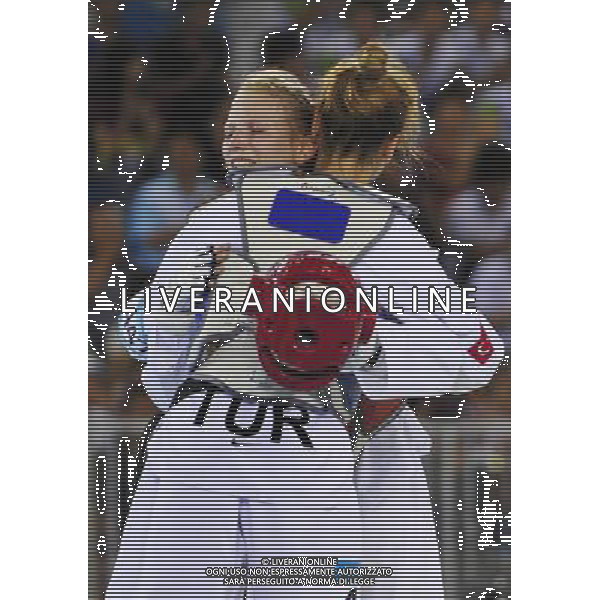 (110820) -- SHENZHEN, Aug. 20, 2011 () -- Anastasia Valueva (back) of Russia hugs with Rukiye Yildirim of Turkey after finishing the women\'s 46kg gold medal match of taekwondo event at the 26th Summer Universiade in Shenzhen, a city of south China\'s Guangdong Province, on Aug. 20, 2011. Anastasia Valueva won the match 5-4, and claimed the gold medal. (/Liang Xu)