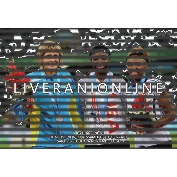 (110819) -- SHENZHEN, Aug. 19, 2011 () -- Gold medalist Nia Sifaatihii Ali of the United States (C), silver medalist Natalya Ivoninskaya of Kazakhstan (L), and bronze medalist Christina Manning of the United States celebrates during the awarding ceremony of women\'s 100m hurdles of athletics event at the 26th Summer Universiade in Shenzhen, a city of south China\'s Guangdong Province, on Aug. 19, 2011. (/Lin Yiguang)