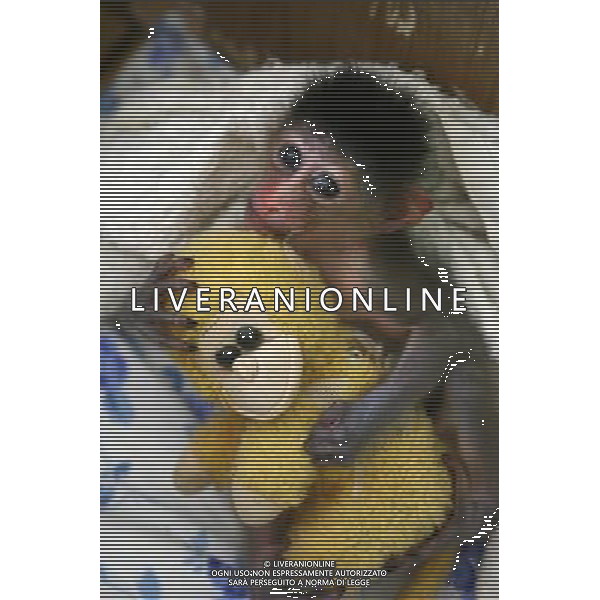 (110819) -- NINGBO, Aug. 19, 2011 () -- A half-month-old mandrill holds a monkey doll in a zoo in Ningbo, east China\'s Zhejiang Province, Aug. 19, 2011. Mandrill is under world\'s first-grade protection. (/Long Hongtao)(mcg)