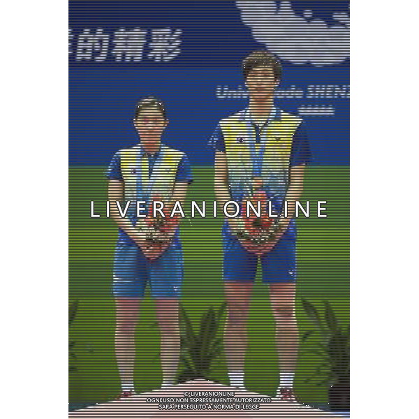 (110822) -- SHENZHEN, Aug. 22, 2011 () -- Shin Baek Cheol (R) and Eom Hye Won of South Korea react during the awarding ceremony of mixed doubles match of badminton at the 26th Summer Universiade in Shenzhen, a city of south China\'s Guangdong Province, on Aug. 22, 2011. Shin Baek Cheol/Eom Hye Won of South Korea won Lee Shengmu/Hsieh Peichen of Chinese Taipei 2-1 to win the gold medal. (/Lui Sui Wai)(wx)