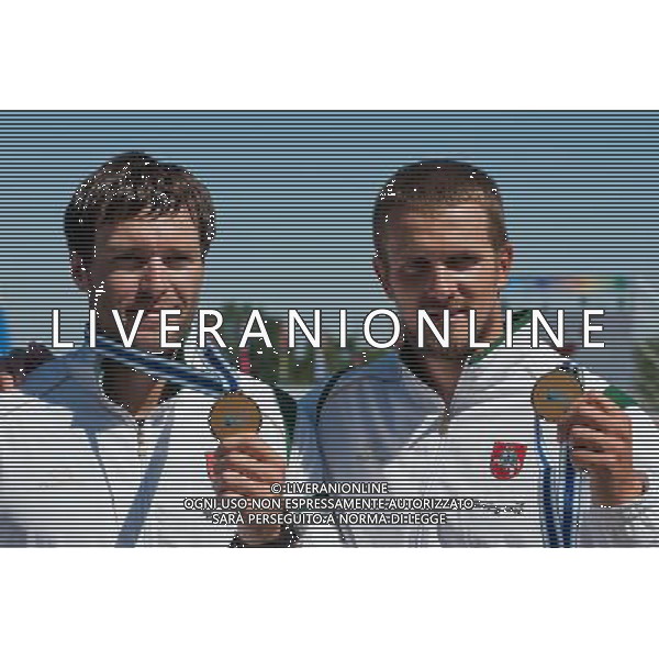 (110822) -- SZEGED, Aug. 22, 2011 () -- Raimundas Labuckas (R) and Tomas Gadeikis from Lithuania pose in the awarding ceremony for the men\'s C2 200m event of the 2011 ICF World Canoe Sprint Championships in Szeged, Hungary, Aug. 21, 2011. They claimed the title in 37.101 seconds. (/Attila Volgyi)