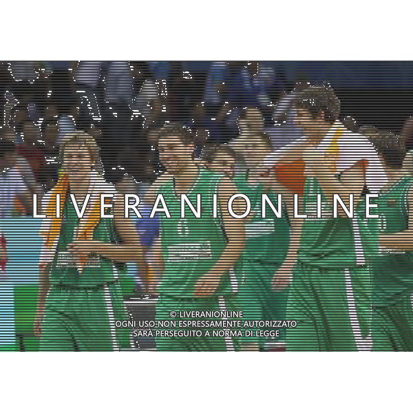 (110822) -- SHENZHEN, Aug. 22, 2011 () -- Osvaldas Matulionis (C) of Lithuania, together with his teammates, step out of the court after winning the bronze medal match of basketball against Russia at the 26th Summer Universiade in Shenzhen, a city of south China\'s Guangdong Province, Aug. 22, 2011. Lithuania won the match 76:74 and claimed the bronze medal of the event. (/Meng Yongmin)