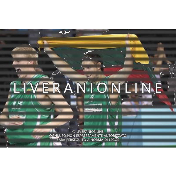 (110822) -- SHENZHEN, Aug. 22, 2011 () -- Gediminas Zyle (L) and Gediminas Orelik of Lithuania step out of the court after winning the bronze medal match of basketball against Russia at the 26th Summer Universiade in Shenzhen, a city of south China\'s Guangdong Province, Aug. 22, 2011. Lithuania won the match 76:74 and claimed the bronze medal of the event. (/Meng Yongmin)