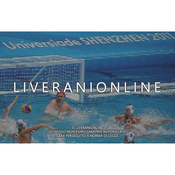 (110823) -- SHENZHEN, Aug. 23, 2011 () -- Goalkeeper Milosh Marinkovikj (red cap) of Macedonia defends during men\'s water polo bronze medal match at the 26th Summer Universiade in Shenzhen, a city of south China\'s Guangdong Province, on Aug. 23, 2011. Macedonia beat the United States 10-7 to win the bronze. (/Lin Yiguang)(wx)