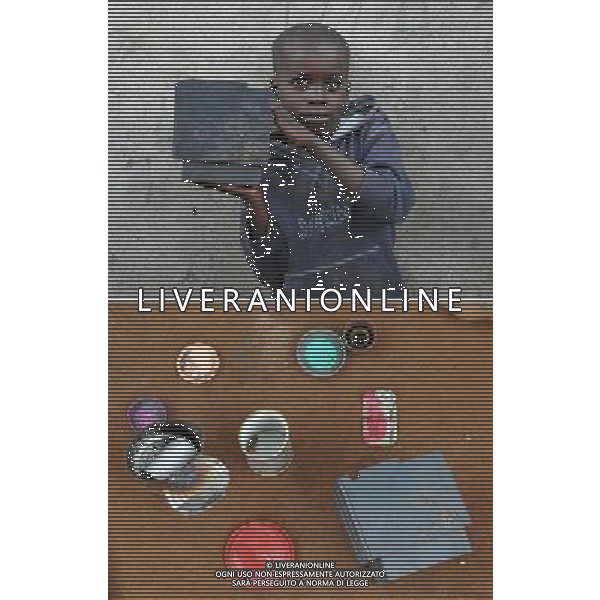 ABIDJAN (COTE D\'IVOIRE), Aug. 26, 2011 Photo taken on Aug. 16, 2011 in Abidjan, Cote d\'Ivoire, shows children living at Attiecoube slum and their toys. Top: Eight year old boy Konate Aboubakar and his favorite toy. Bottom: All of Konate Aboubakar\'s toys. (/Ding Haitao) (lr)