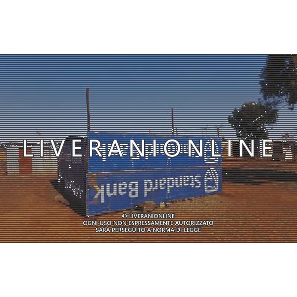 (110831) -- JOHANNESBURG, Aug. 31, 2011 () -- A sheet iron house made from a Standard Chartered bank billboard is seen at the Mritini Informal settlement, Johannesburg, South Africa, Aug. 25, 2011. One of the most common landscapes in Johannesburg and even the whole South Africa is slum, some of which stretche for miles and are populated with hundreds and thousands of people. For most of the inhabitants, their houses are made from scrap materials such as wooden stakes or corrugated metal. Although living in a shanty town, poverty cannot stop their pursuit for beauty, nor ruin their impulse in life. Therefore, they find a way to express their love for life, to painting on the iron sheet house.(/Fei Maohua) (msq)