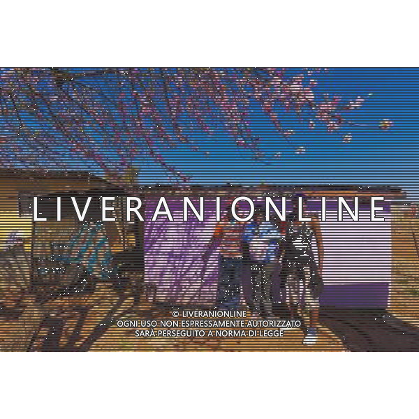 (110831) -- JOHANNESBURG, Aug. 31, 2011 () -- Amos Mkhuma and his girls stand in front of their sheet iron house at the Sweet Water Informal settlement, Johannesburg, South Africa, Aug. 25, 2011. One of the most common landscapes in Johannesburg and even the whole South Africa is slum, some of which stretche for miles and are populated with hundreds and thousands of people. For most of the inhabitants, their houses are made from scrap materials such as wooden stakes or corrugated metal. Although living in a shanty town, poverty cannot stop their pursuit for beauty, nor ruin their impulse in life. Therefore, they find a way to express their love for life, to painting on the iron sheet house.(/Fei Maohua) (msq)