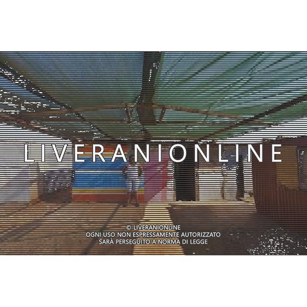 (110831) -- JOHANNESBURG, Aug. 31, 2011 () -- Ayanda Magaqa stands in front of her sheet iron house at the Thembelihle Informal settlement, Johannesburg, South Africa, Aug. 25, 2011. One of the most common landscapes in Johannesburg and even the whole South Africa is slum, some of which stretche for miles and are populated with hundreds and thousands of people. For most of the inhabitants, their houses are made from scrap materials such as wooden stakes or corrugated metal. Although living in a shanty town, poverty cannot stop their pursuit for beauty, nor ruin their impulse in life. Therefore, they find a way to express their love for life, to painting on the iron sheet house.(/Fei Maohua) (msq)