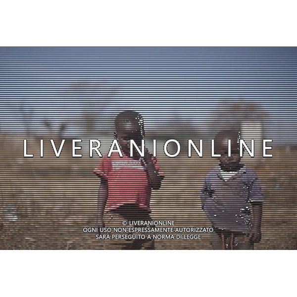 JOHANNESBURG , Sept. 01, 2011 4 year old Fuwdo chews a plastic straw he found in trash in Slovo Part of Soweto, Johannesburg, South Africa, Aug. 26, 2011. Children in the shanty towns don\'t have fancy toys like transformers, barbies or remote control airplanes, but they have a lot of fun playing with a piece of wire, a ball, a discarded circuit board or even a piece of paper. These so called toys bring happiness to the children, though heart breaking it may seem to others. (/Fei Maohua) (xhn)