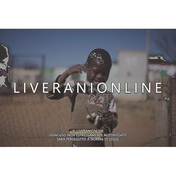 JOHANNESBURG , Sept. 01, 2011 7 year old Public Chauke poses with his new toy, a self made wire wheel in Motswaledi Informal settlement of Soweto, Johannesburg, South Africa, Aug. 24, 2011. Children in the shanty towns don\'t have fancy toys like transformers, barbies or remote control airplanes, but they have a lot of fun playing with a piece of wire, a ball, a discarded circuit board or even a piece of paper. These so called toys bring happiness to the children, though heart breaking it may seem to others. (/Fei Maohua) (xhn)