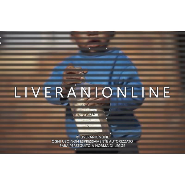 JOHANNESBURG , Sept. 01, 2011 1 year old Phelo holds his toy, a wine bottle, in Thembelihle Informal Settlement, Johannesburg, South Africa, Aug. 25, 2011. Children in the shanty towns don\'t have fancy toys like transformers, barbies or remote control airplanes, but they have a lot of fun playing with a piece of wire, a ball, a discarded circuit board or even a piece of paper. These so called toys bring happiness to the children, though heart breaking it may seem to others. (/Fei Maohua) (xhn)