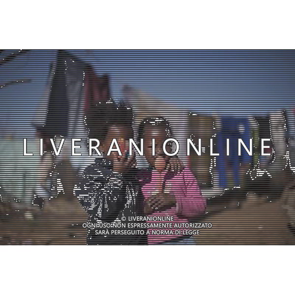 JOHANNESBURG , Sept. 01, 2011 4 year old Sesethu Amanda Yutwana(L) and Nunu Shubi pose with their new toys they just found, a broken toy vehicle and a plastic spoon, in Motswaledi Informal settlement of Soweto, Johannesburg, South Africa, Aug. 24, 2011. Children in the shanty towns don\'t have fancy toys like transformers, barbies or remote control airplanes, but they have a lot of fun playing with a piece of wire, a ball, a discarded circuit board or even a piece of paper. These so called toys bring happiness to the children, though heart breaking it may seem to others. (/Fei Maohua) (xhn)