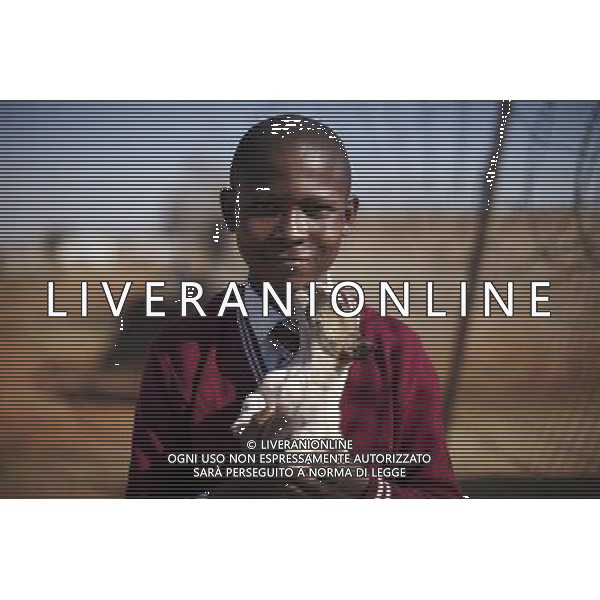 JOHANNESBURG , Sept. 01, 2011 10 year old Thulani Hlubane plays with a puppy in Orange Farm Extension in 6A Informal Settlement, Johannesburg, South Africa, Aug. 25, 2011. Children in the shanty towns don\'t have fancy toys like transformers, barbies or remote control airplanes, but they have a lot of fun playing with a piece of wire, a ball, a discarded circuit board or even a piece of paper. These so called toys bring happiness to the children, though heart breaking it may seem to others. (/Fei Maohua) (xhn)