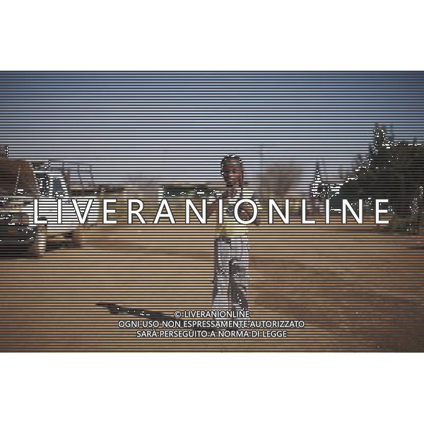 JOHANNESBURG , Sept. 01, 2011 7 year old Musa Khulu plays with a piece of metal gear in Orange Farm Extension in 6A Informal Settlement in Johannesburg, South Africa, Aug. 25, 2011. Children in the shanty towns don\'t have fancy toys like transformers, barbies or remote control airplanes, but they have a lot of fun playing with a piece of wire, a ball, a discarded circuit board or even a piece of paper. These so called toys bring happiness to the children, though heart breaking it may seem to others. (/Fei Maohua) (xhn)