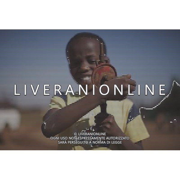 JOHANNESBURG , Sept. 01, 2011 7 year old Musa Khulu plays with a piece of metal gear in Orange Farm Extension in 6A Informal Settlement in Johannesburg, South Africa, Aug. 25, 2011. Children in the shanty towns don\'t have fancy toys like transformers, barbies or remote control airplanes, but they have a lot of fun playing with a piece of wire, a ball, a discarded circuit board or even a piece of paper. These so called toys bring happiness to the children, though heart breaking it may seem to others. (/Fei Maohua) (xhn)