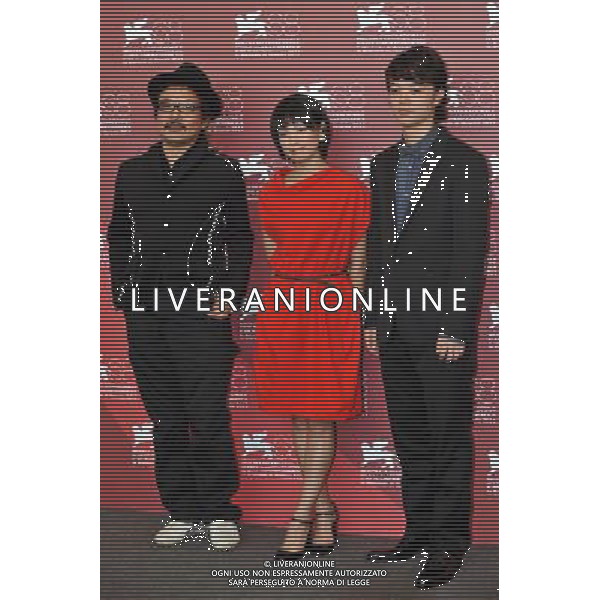 VENICE, Sept. 6, 2011 Japanese director Sion Sono (L), actors Fumi Nikaidopose (C) and Shota Sometani pose during the photo call for the film \'Himizu\' at the 68th Venice International Film Festival in Venice, Italy, Sept. 6, 2011. (/Wang Qingqin) (djj)