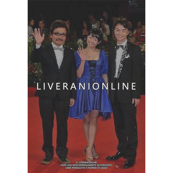 (110906) -- VENICE, Sept. 6, 2011 () -- Japanese director Sion Sono (L), actors Fumi Nikaidopose (C) and Shota Sometani pose on the red carpet for the premiere of the film \'Himizu\' at the 68th Venice Film Festival in Venice, Italy, Sept. 6, 2011. (/Wang Qingqin)