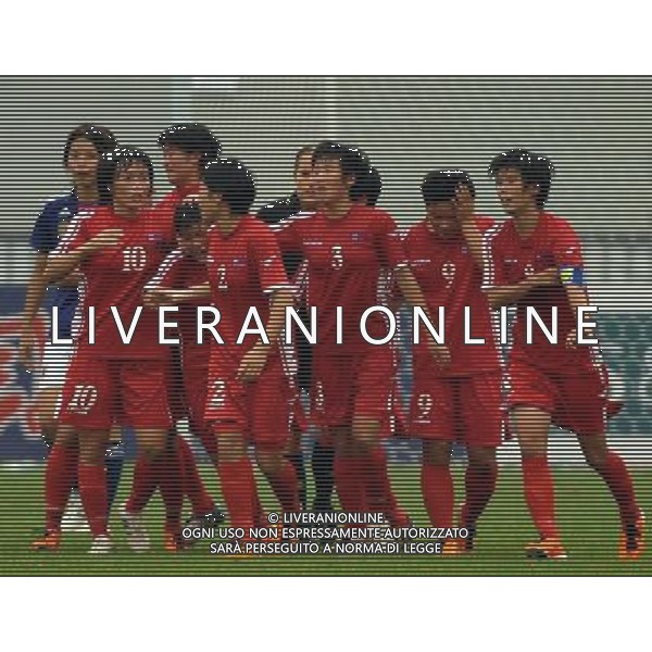 JINAN, Sept. 8, 2011 The Democratic People\'s Republic of Korea (DPRK)\'s Kim Jo Ran (4th L) acceptes congratulations after scoring against Japan at the Asian women\'s football qualifier for the 2012 London Olympics in Jinan, east China\'s Shandong Province, Sept. 8, 2011. The match ended in a 1 1 draw. (/Zhu Zheng)(dx)
