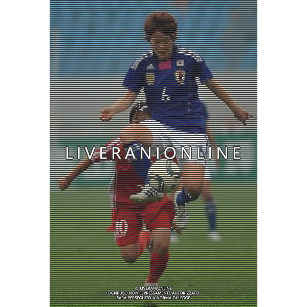 JINAN, Sept. 8, 2011 Japan\'s Sakaguchi Mizuho (top) vies for the ball during the match against the Democratic People\'s Republic of Korea (DPRK) at the Asian women\'s football qualifier for the 2012 London Olympics in Jinan, east China\'s Shandong Province, Sept. 8, 2011. The match ended in a 1 1 draw. (/Zhu Zheng)(dx)