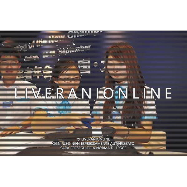 (110913) -- DALIAN, Sept. 13, 2011 () -- Volunteers are seen busy working prior to the World Economic Forum Annual Meeting of the New Champions in Dalian, northeast China\'s Liaoning Province, Sept. 13, 2011. The World Economic Forum Annual Meeting of the New Champions, also known as the Summer Davos Forum, will kick off in Dalian on Sept. 14. (/Li Yuze) (cxy)