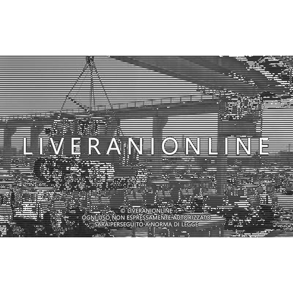 (110930) -- BEIJING, Sept. 30, 2011 () -- File photo taken in 1961 shows a China-made \'Dongfanghong\' tractor being lifted by crane at the Luoyang No.1 Tractor Factory in Luoyang, central China\'s Henan Province. Can you imagine what the industry of China, now enjoys the title of \'World Factory\', was like a century ago? In 1905, when the imperial Qing government sent five senior officials to Japan and some Western countries to visit, seeking for solutions to save the decaying empire, \'Yanchang Oil Plant\', the first-ever oil enterprise in the Chinese mainland, was established in Yan\'an of northwest China\'s Shaanxi Province. In 1907, Yanchang drilled the first onshore oil well \'Yanyi Well\', starting the oil production in the Chinese mainland. However, in 1907, the oil output could only reach 1 to 1.5 tonnes per day. More than 100 years passed, Yanchang, now called Shaanxi Yanchang Petroleum (Group) Co., LTD, has made great development. In 2007, the crude oil output, oil refining and processing, and sales of oil products of Yanchang respectively exceeded 10 million tonnes, engendering it into an emerging large oilfield with the output of 10 million tonnes. Yanchang is an epitome of Chinese industry\'s centennial development since the 1911 Revolution. The 1911 Revolution, led by Dr. Sun Yat-sen, overthrew the Qing Dynasty (1644-1911) and also put an end to thousands of years of feudalist governance in China. After the revolution, Chinese industry developed as many Chinese factories, in the fields such as textile, flour, match, and steel and iron, were established at that time. However, most Chinese factories were in small scale and did not thrive for a long time. After the founding of the People\'s Republic of China in 1949, step by step, Chinese industry has formed an independent and integral modern industry system with considerable scale and relatively high technical level. Especially in the 30 years after the Chinese government implement ©AG ALDO LIVERANI SAS ITALY ONLY *** Local Caption *** .