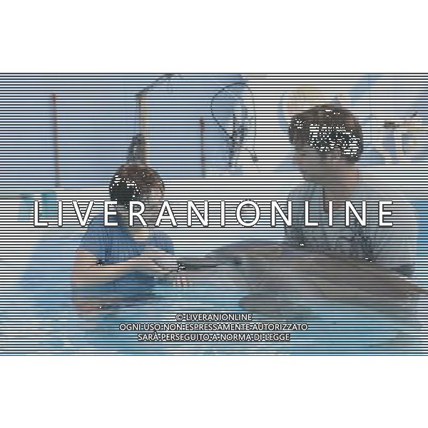 NATHAN GAMBLE as Sawyer Nelson and HARRY CONNICK, JR. as Dr. Clay Haskett with WINTER in Alcon Entertainment\'s family adventure Dolphin Tale a Warner Bros. Pictures release. © LFI - PHOTOSHOT - AG. ALDO LIVERANI SAS ITALY ONLY