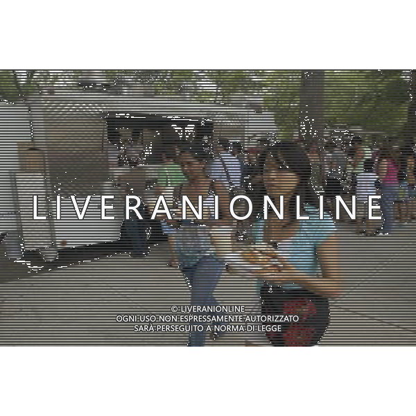 Customers with plates from the Latin food vendors in the Red Hook neighborhood of Brooklyn in New York. The popular vendors sell cuisine from various Latin American countries out of a corner of Red Hook Park. Due to city health regulations, the vendors, who used to operate out of tents, had to purchase trucks and pass inspection at considerable cost. The businesses started over 30 years ago near the soccer fields in the park that are popular with Hispanic immigrants. new york city - situazioni ©photoshot/AG ALDO LIVERANI SAS ITALY ONLY