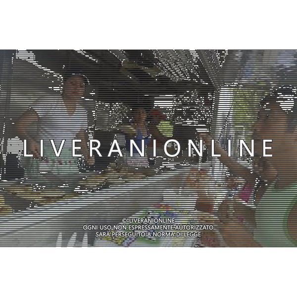 A cook fries Salvadorian pupusas as hungry customers wait at a Latin food vendor in the Red Hook neighborhood of Brooklyn in New York on Sunday, July 20, 2008. The popular vendors sell cuisine from various Latin American countries out of a corner of Red Hook Park. Due to city health regulations, the vendors, who used to operate out of tents, had to purchase trucks and pass inspection at considerable cost. Their season was supposed to start in May but ended up starting this weekend. The businesses started over 30 years ago near the soccer fields in the park that are popular with Hispanic immigrants. ( Richard B. Levine) new york city - situazioni ©photoshot/AG ALDO LIVERANI SAS ITALY ONLY