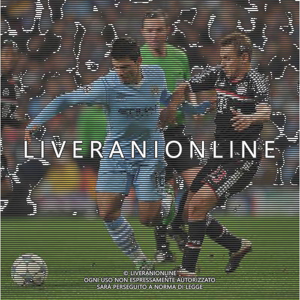 Manchester City\'s Sergio Aguero battles his way past Bayern Munich\'s Rafinha Football - UEFA Champions League Group A - Manchester City v Bayern Munich - Wed 07 Dec 2011 - Etihad Stadium - Manchester Œ© CameraSport - 43 Linden Ave. Countesthorpe. Leicester. England. LE8 5PG - Tel: +44 (0) 116 277 4147 - admin@camerasport.com - www.camerasport.com ©AG ALDO LIVERANI SAS - ITALY ONLY *** Local Caption *** .