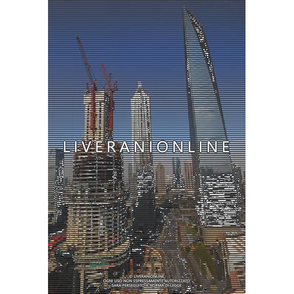 (120117) SHANGHAI, Jan. 17, 2012 () Photo taken on Jan. 17, 2012 shows the Shanghai Tower (L) under construction alongside the Jin Mao Tower and Shanghai World Financial Center in Shanghai, east China. Work crews have completed the foundation for the world\'s second tallest building ahead of schedule and are now rushing to construct the ground structure of the 632 meter Shanghai Tower, second only to the 828 meter tall Burj Khalifa in Dubai. () (zgp) ©photoshot/ag aldo liverani italy only