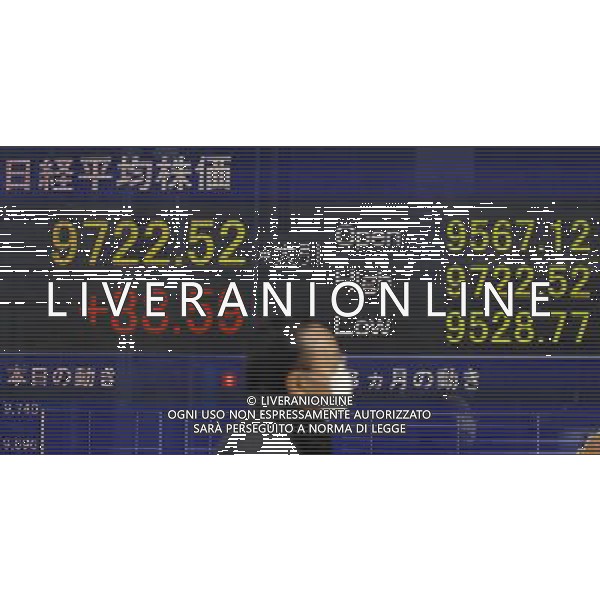 (120228) -- TOKYO, Feb. 287, 2012 () -- A man walks past a screen displaying stock information in Tokyo, capital of Japan, on Feb. 28, 2012. The 225-issue Nikkei Stock Average ended up 88.59 points, or 0. 92 percent, from Monday at 9,722.52, the highest close since Aug. 2, when it finished at 9,844.59. (/Kenichiro Seki) (msq) ©PHOTOSHOT/AG ALDO LIVERANI SAS - ITALY ONLY -