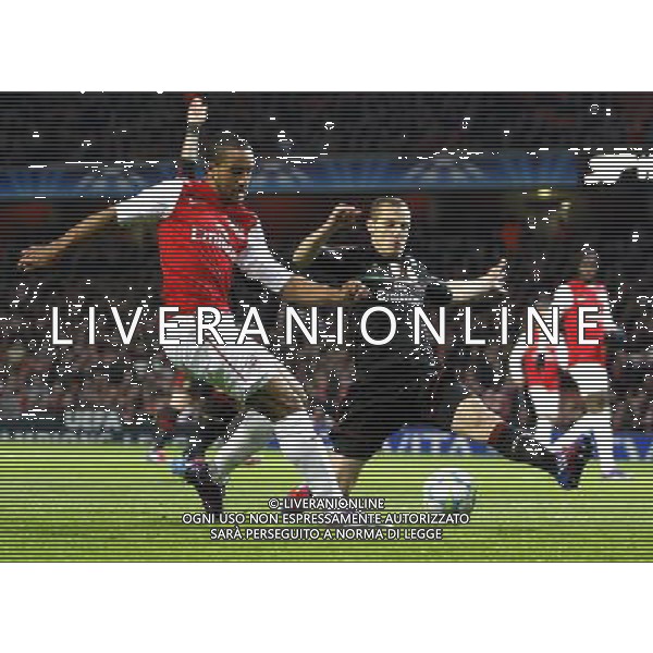 Arsenal\'s Theo Walcott battles with AC Milan\'s Djamel Mesbah Football - UEFA Champions League Group F - Arsenal v AC Milan - Tue 06 Mar 2012 - Emirates Stadium - London © CameraSport - 43 Linden Ave. Countesthorpe. Leicester. England. LE8 5PG - Tel: +44 (0) 116 277 4147 - admin@camerasport.com - www.camerasport.com AG ALDO LIVERANI S A S ONLY ITALY