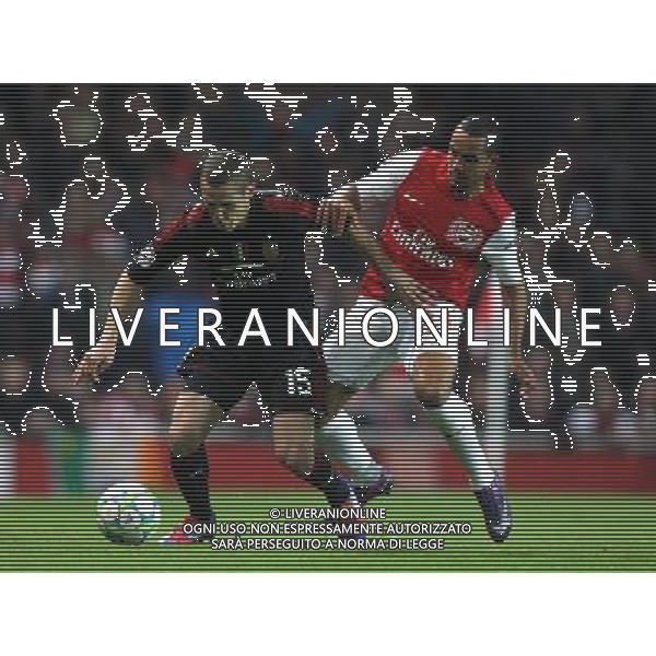 Arsenal\'s Theo Walcott battles with AC Milan\'s Djamel Mesbah Football - UEFA Champions League Group F - Arsenal v AC Milan - Tue 06 Mar 2012 - Emirates Stadium - London © CameraSport - 43 Linden Ave. Countesthorpe. Leicester. England. LE8 5PG - Tel: +44 (0) 116 277 4147 - admin@camerasport.com - www.camerasport.com AG ALDO LIVERANI S A S ONLY ITALY