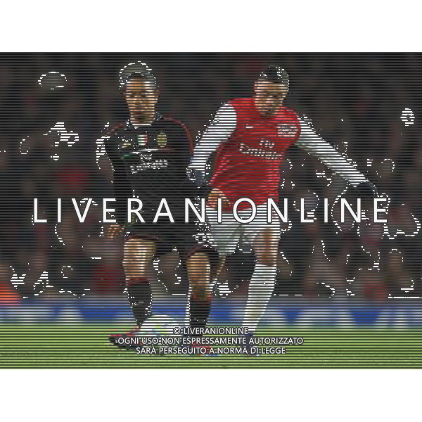 AC Milan\'s Urby Emanuelson battles with Arsenal\'s Alex Oxlade-Chamberlain Football - UEFA Champions League Group F - Arsenal v AC Milan - Tue 06 Mar 2012 - Emirates Stadium - London © CameraSport - 43 Linden Ave. Countesthorpe. Leicester. England. LE8 5PG - Tel: +44 (0) 116 277 4147 - admin@camerasport.com - www.camerasport.com AG ALDO LIVERANI S A S ONLY ITALY